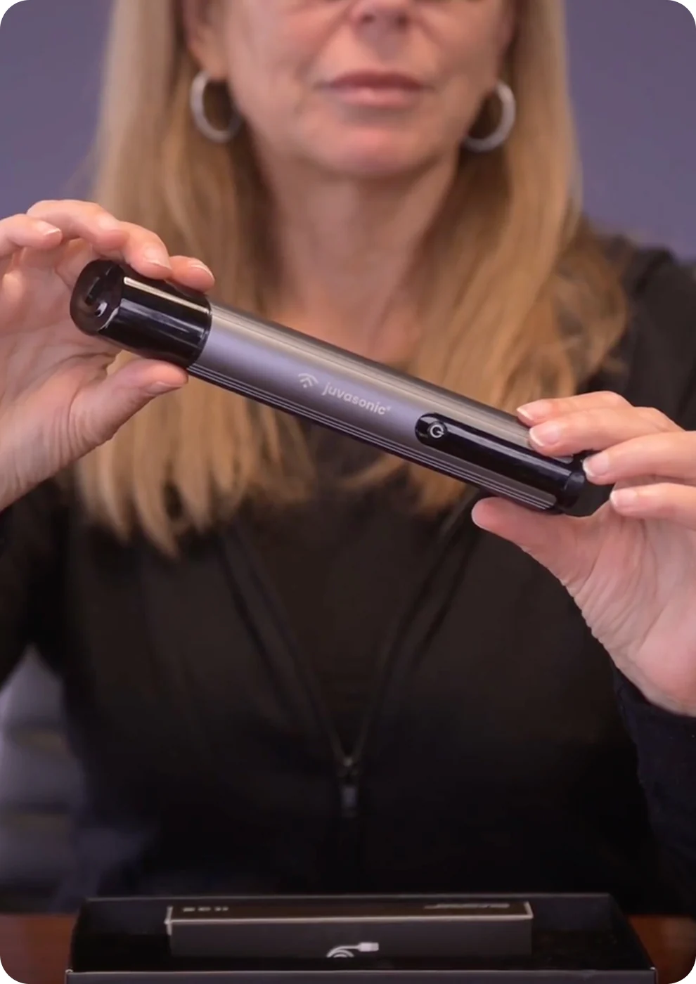 A cosmetic nurse unboxing a juvasonic device