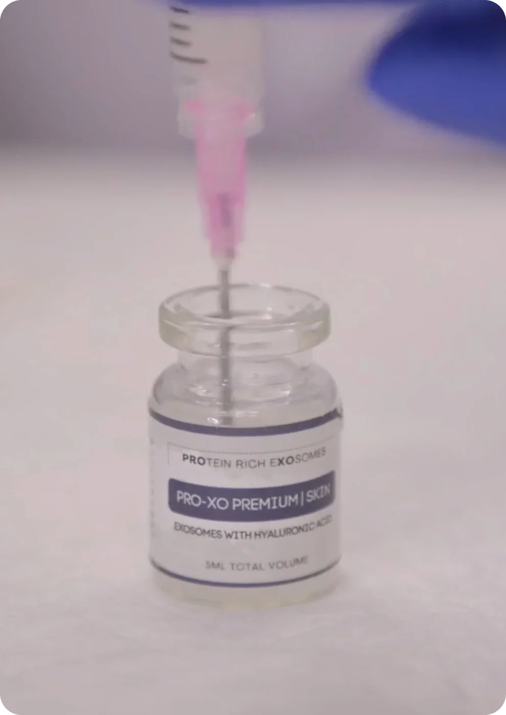 Photo of a needle inside an exosome bottle