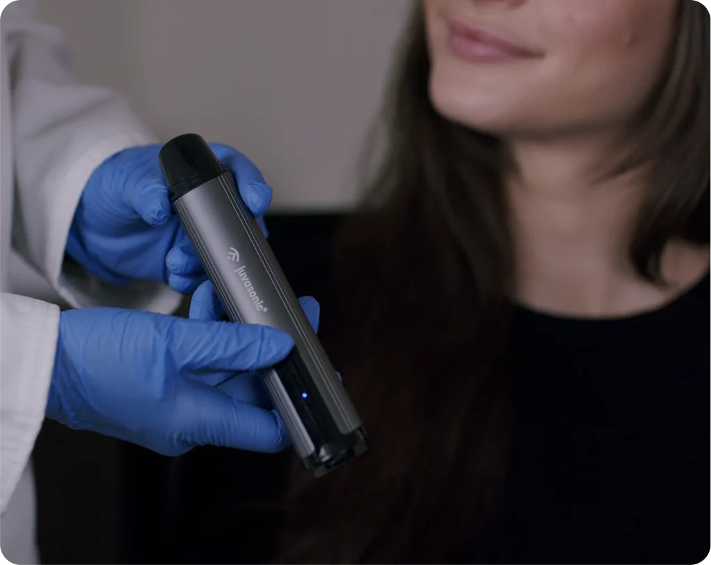 A doctor holding the juvasonic device