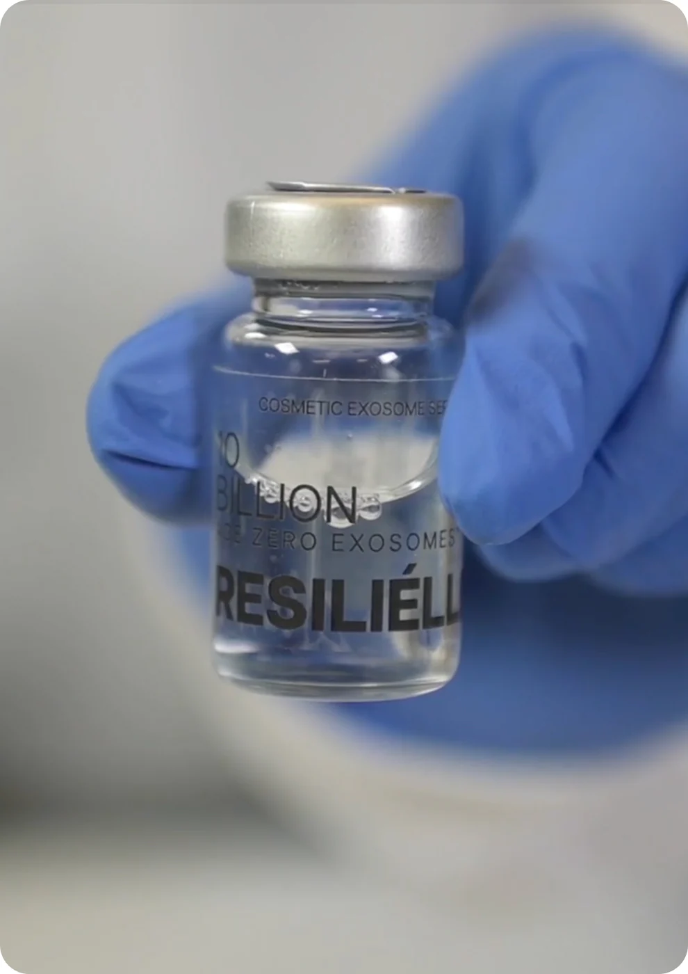 A gloved hand holding a vial of ten billion Resilielle Age Zero exosomes