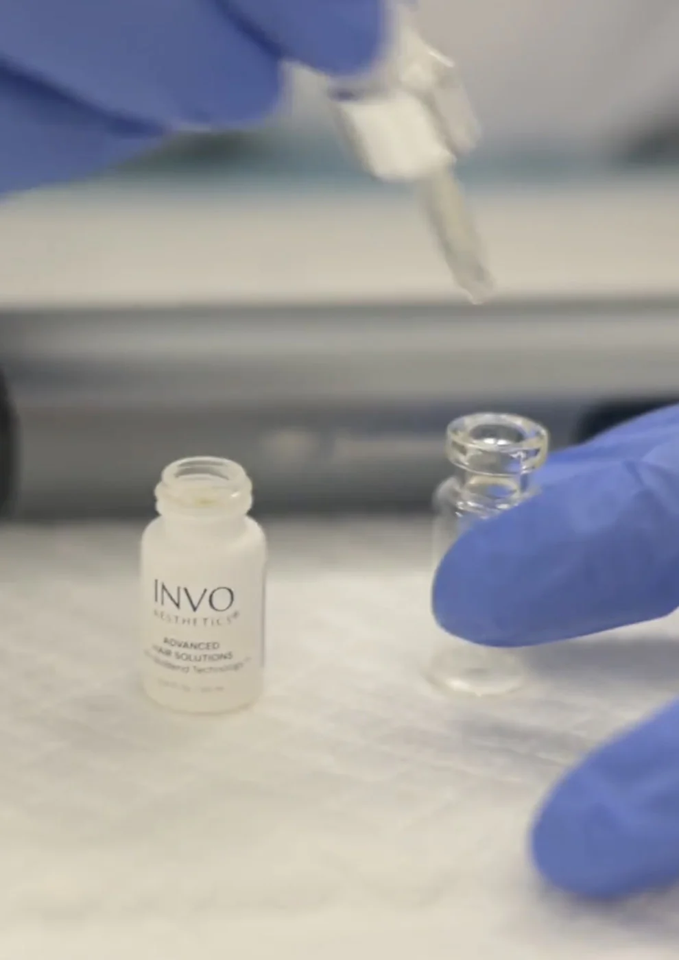A doctor unscrewing the cap of a invo brighting bottle