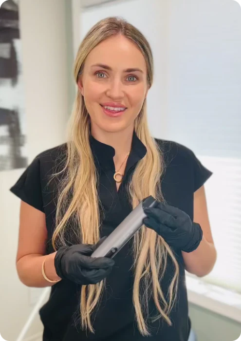 A cosmetic nurse holding the juvasonic device